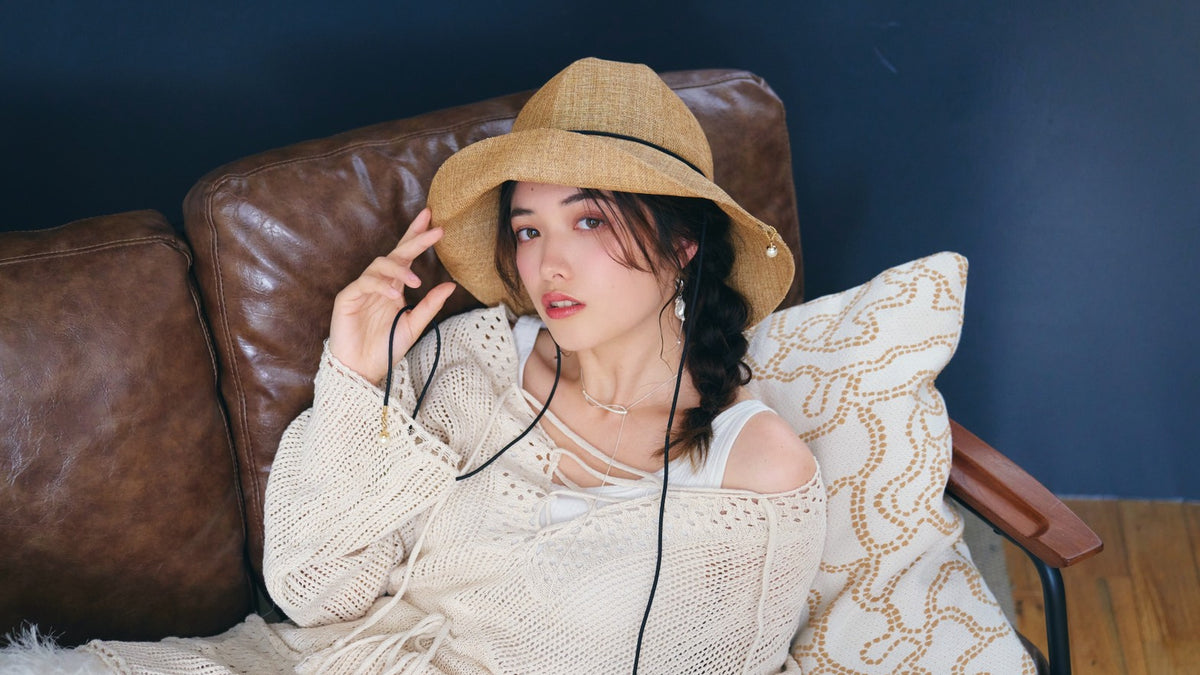 ETRE'MIU editorial hero image featuring a model wearing a straw hat